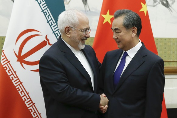 Chinese State Councillor and Foreign Minister Wang Yi meets Iranian Foreign Minister Mohammad Javad Zarif at Diaoyutai state guesthouse in Beijing, Sunday, May 13, 2018. (Thomas Peter/Pool Photo via A ...