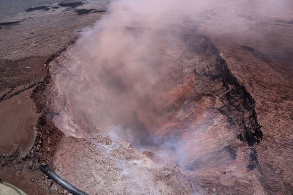 In this photo released by U.S. Geological Survey, a plume of ash rises from the Puu Oo vent on Hawaii's Kilaueaa Volcano Thursday, May 3, 2018 in Hawaii Volcanoes National Park. Hawaii's Kilauea volca ...