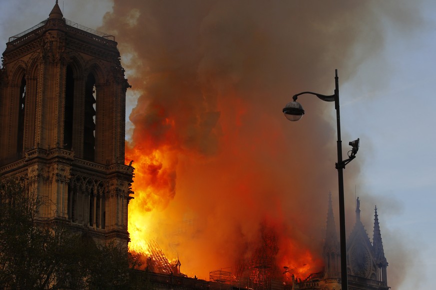 Notre Dame cathedral is burning in Paris, Monday, April 15, 2019. A catastrophic fire engulfed the upper reaches of Paris' soaring Notre Dame Cathedral as it was undergoing renovations Monday, threate ...