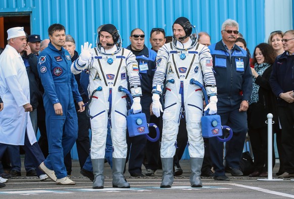 KAZAKHSTAN - OCTOBER 11, 2018: Roscosmos cosmonaut Alexei Ovchinin and NASA astronaut Nick Hague (L-R centre) of the ISS Expedition 57/58 prime crew wear suits at a send-off ceremony ahead of their So ...