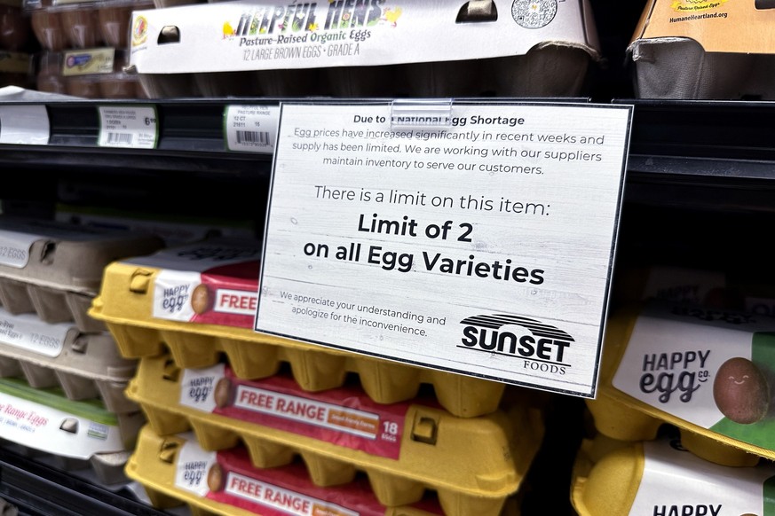 A sign is mounted on a shelve of eggs at a grocery store in Northbrook, Ill., Friday, Feb. 28, 2025. (AP Photo/Nam Y. Huh)