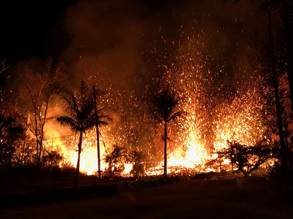 A new fissure spraying lava fountains as high as about 230 feet (70 m), according to United States Geological Survey, is shown from Luana Street in Leilani Estates subdivision on Kilauea Volcano's low ...