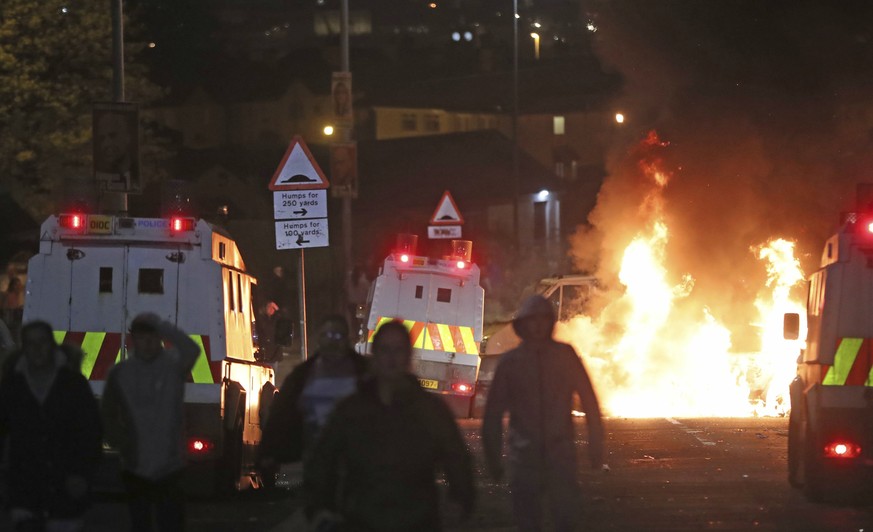 A car burns after petrol bombs were thrown at police in Creggan, Londonderry, in Northern Ireland, Thursday, April 18, 2019. (Niall Carson/PA via AP)