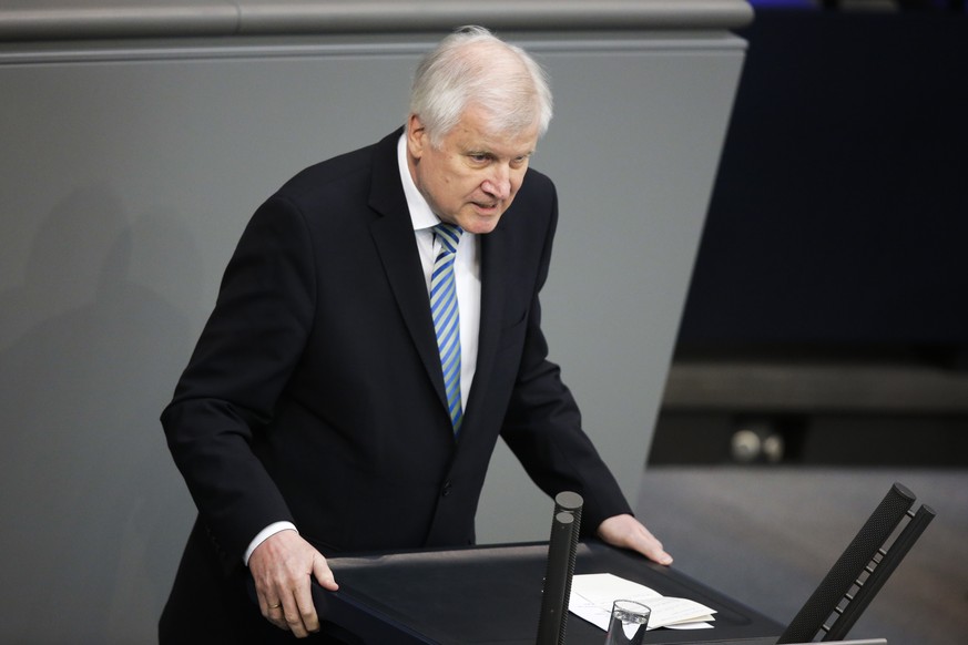 German Interior Minister Horst Seehofer delivers his speech during a meeting of the German federal parliament, Bundestag, at the Reichstag building in Berlin, Germany, Thursday, May 17, 2018. (AP Phot ...