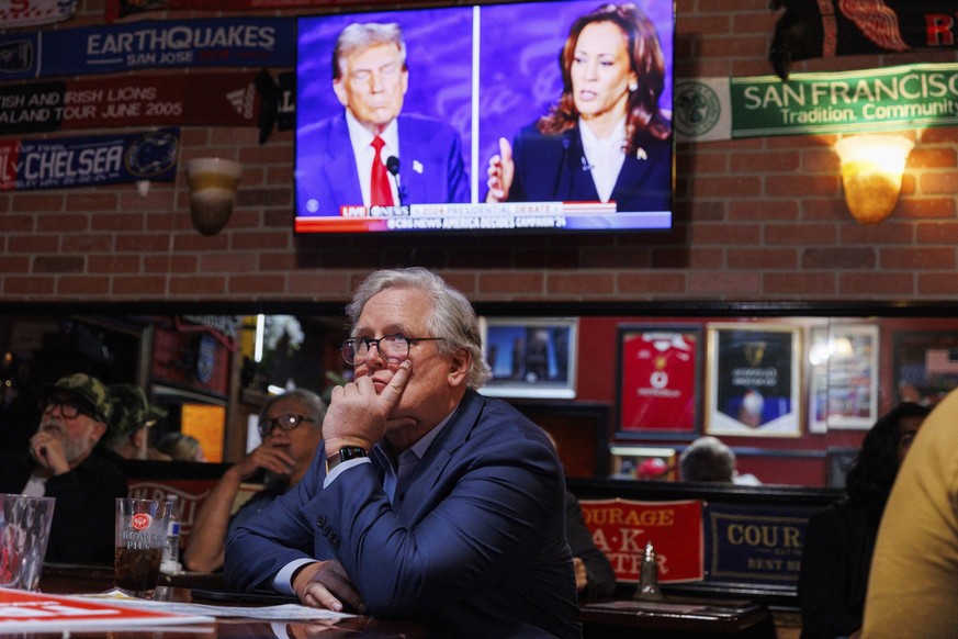 San Francisco Republican party Chair John Dennis watches a presidential debate between Democratic presidential nominee Vice President Kamala Harris and Republican presidential nominee former President ...