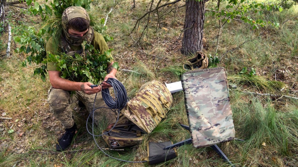 A Ukrainian soldier of the 61st Separate Mechanized Brigade uses the Starlink system during military exercises in the Chernihiv region, Ukraine, June 2023 (Photo by Maxym Marusenko/NurPhoto via Getty  ...