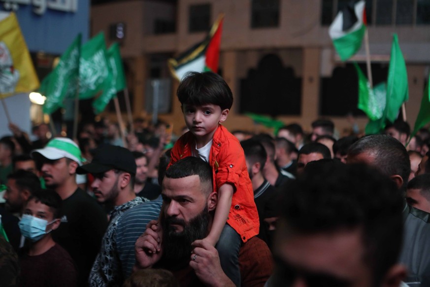 Palestinians waving national and Hamas flags shout slogans during rally to suport Hamas movements Palestinians waving national and Hamas flags shout slogans during rally to suport Hamas movements and  ...