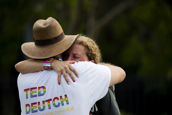 Rep. Debbie Wasserman Schultz, D-Fla., is comforted after a truck drove into a crowd of people during The Stonewall Pride Parade and Street Festival in Wilton Manors, Fla., Saturday, June 19, 2021. A  ...