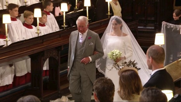 In this frame from video, Meghan Markle walks down the aisle with Prince Charles for her wedding ceremony at St. George's Chapel in Windsor Castle in Windsor, near London, England, Saturday, May 19, 2 ...