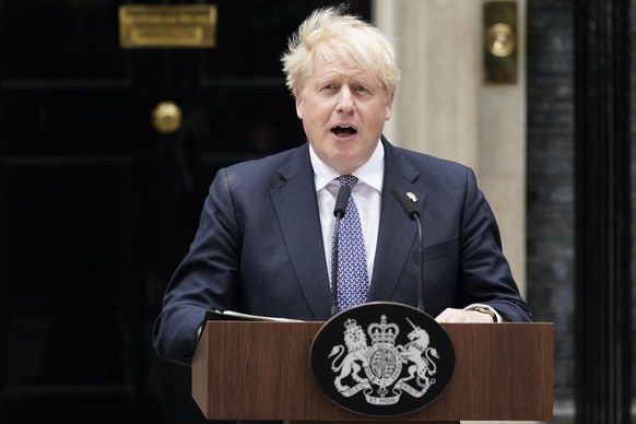 Prime Minister Boris Johnson reads a statement outside 10 Downing Street, London, formally resigning as Conservative Party leader, in London, Thursday, July 7, 2022. Johnson said Thursday he will rema ...