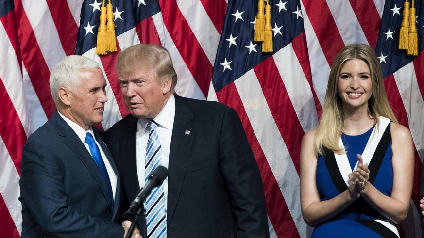 NEW YORK, NY - JULY 16: (L to R) Newly selected vice presidential running mate Mike Pence, governor of Indiana, stands with Republican presidential candidate Donald Trump as Ivanka Trump looks on duri ...