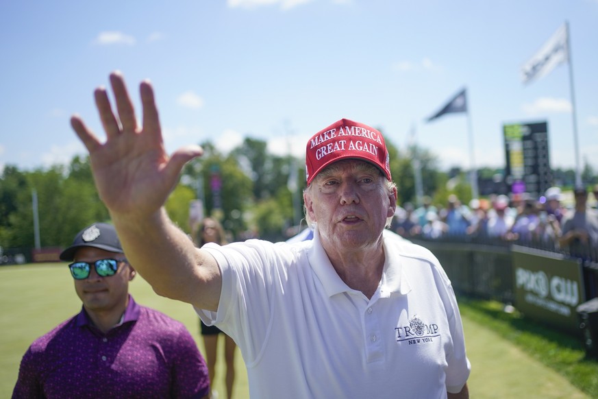 FILE - Former President Donald Trump greets supporters and sign autographs during the final round of the Bedminster Invitational LIV Golf tournament at his golf course in Bedminster, N.J., Aug. 13, 20 ...