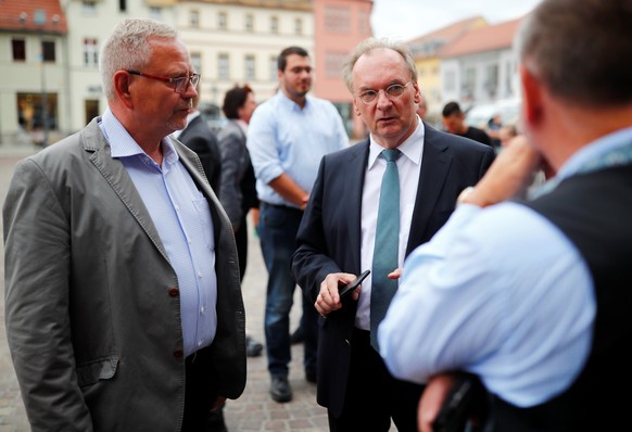 Reiner Haseloff, Prime Minister of the state of Saxony-Anhalt and Bernd Hauschild, Mayor of the City of Koethen, are seen before a church service after a 22-year-old German man died in the eastern tow ...