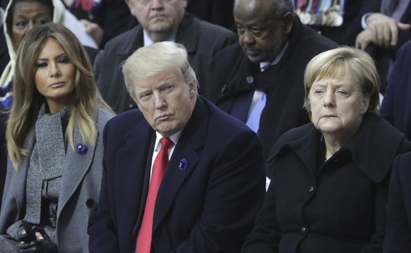 November 11, 2018 - Paris, France - U.S. President Donald Trump sits between German Chancellor Angela Merkel, right, and first lady Melania Trump during events marking the Centennial of Armistice Day  ...