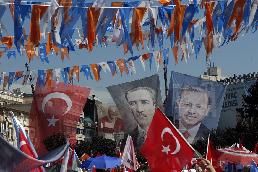 FILE - In this Thursday, June 14, 2018 file photo, banners of Turkish Republic founder Mustafa Kemal Ataturk, centre and Turkey&#039;s current President Recep Tayyip Erdogan, right, decorate an electi ...