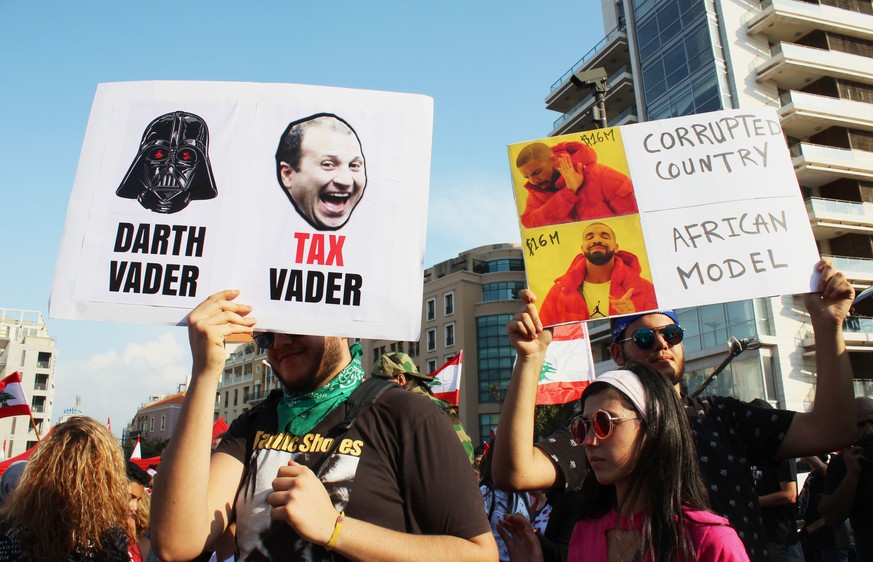 October 20, 2019, Beirut, Beirut, Lebanon: Lebanese demonstrators wave national flags as they take part in a protest against dire economic conditions in Beirut on October 20, 2019. Thousands continued ...