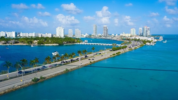 Aerial view of waterfront residential and office buildings Biscayne Bay on sunny cloudless morning in Miami, Florida., Aerial view of waterfront residential and office buildings on Intracoastal Waterw ...
