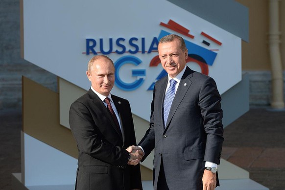 SAINT PETERSBURG - SEPTEMBER 05: In this handout image provided by Host Photo Agency, Russian President Vladimir Putin (L) and Prime Minister of Turkey Recep Tayyip Erdogan shake hands during an offic ...