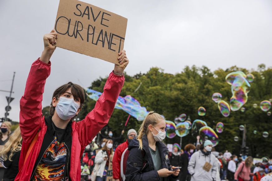 BERLIN, GERMANY - SEPTEMBER 25: Climate activists gather on a &quot;Global Day of Action&quot; organized by the Fridays for Future climate change movement during the coronavirus pandemic on September  ...