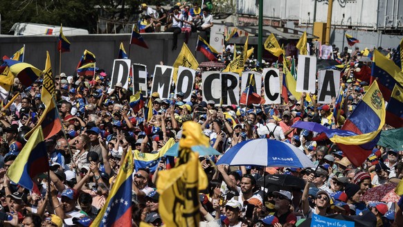 February 2, 2019 - Caracas, Miranda, Venezuela - Large crowd of president Juan Guaido s supporters seen holding several placards during a protest against Maduro. Opposition supporters take part in a r ...