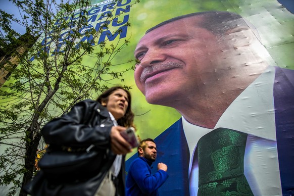 Pedestrians walk past an election campaign billboards of Turkish President and People&#039;s Alliance&#039;s presidential candidate Recep Tayyip Erdogan in Istanbul, Turkey, Thursday, May 4, 2023. (AP ...