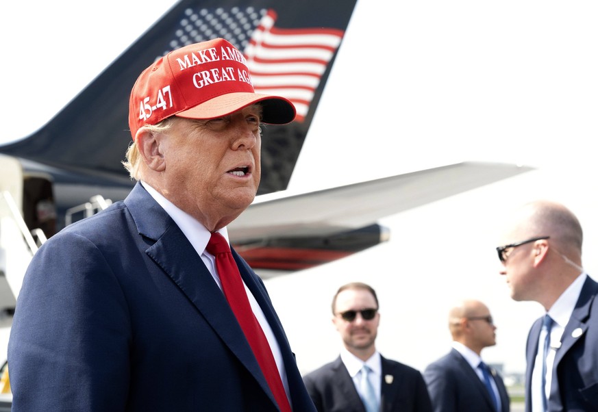 April 10, 2024, Atlanta, Georgia, USA: Wearing his signature red baseball cap with slogan Make America Great Again former American President DONALD J. TRUMP, 77, greets crowd as he arrives at on his p ...