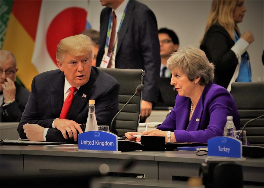 US President Donald Trump (L) talks to British Prime Minister Theresa May (R) during a plenary session of the G20 Summit in Buenos Aires, Argentina, 30 November 2018. The G20 Summit brings together th ...