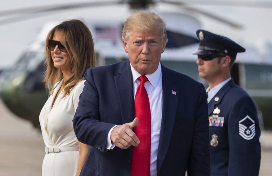 President Donald Trump with first lady Melania Trump gestures upon arrival at Andrews Air Force Base, Md., Sunday, July 7, 2019. (AP Photo/Manuel Balce Ceneta)