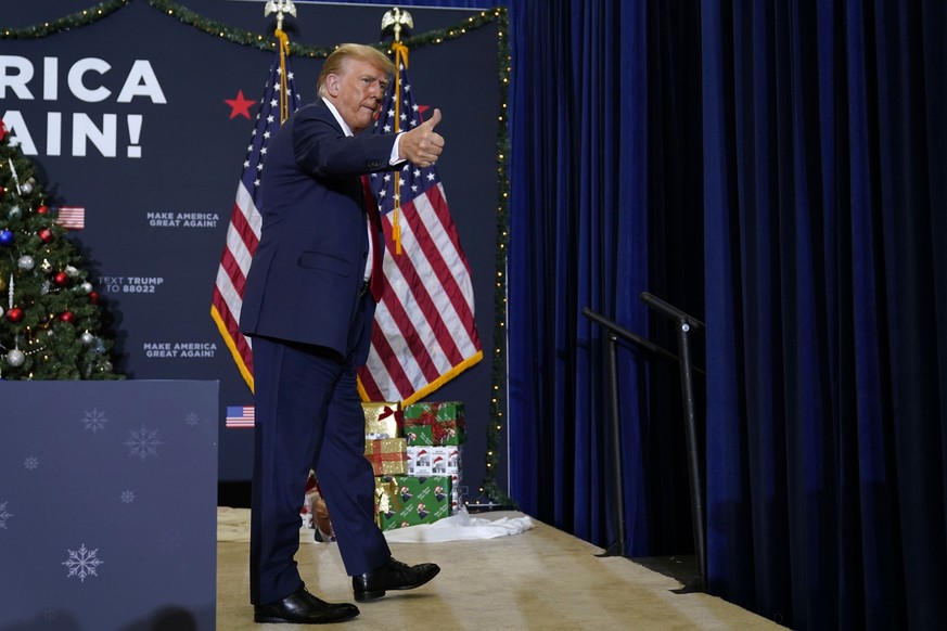 Former President Donald Trump walks off stage after speaking at a commit to caucus rally, Tuesday, Dec. 19, 2023, in Waterloo, Iowa. (AP Photo/Charlie Neibergall)