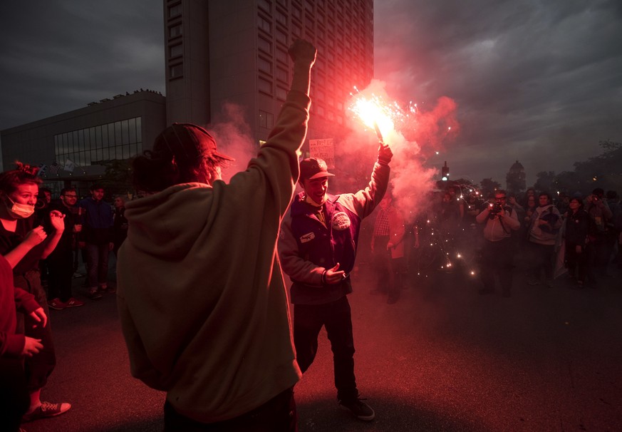 Anti-G7 protesters throw flares while demonstrating ahead of the G7 Summit in Quebec City, Thursday, June 7, 2018. (Darren Calabrese/The Canadian Press via AP)