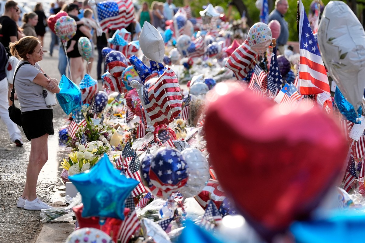 A well-wisher pauses at a growing makeshift memorial set up at Turning Point USA headquarters for Charlie Kirk, the co-founder and CEO of the organization, who was shot and killed last week at a Utah  ...