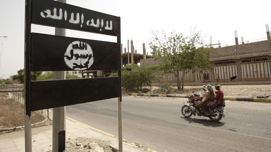 FILE - In this Friday, June 15, 2012 file photo, an al-Qaida logo is seen on a street sign in the town of Jaar in southern Abyan province, Yemen. Arabic on the logo reads, &quot;There is no god but Go ...