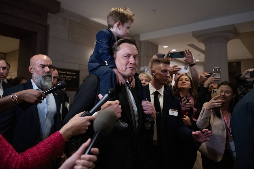 Elon Musk 12/05 UNITED STATES - DECEMBER 5: Elon Musk with his son, makes his way to a meeting in the Capitol Visitor Center with House and Senate Republicans to talk about President-elect Donald Trum ...