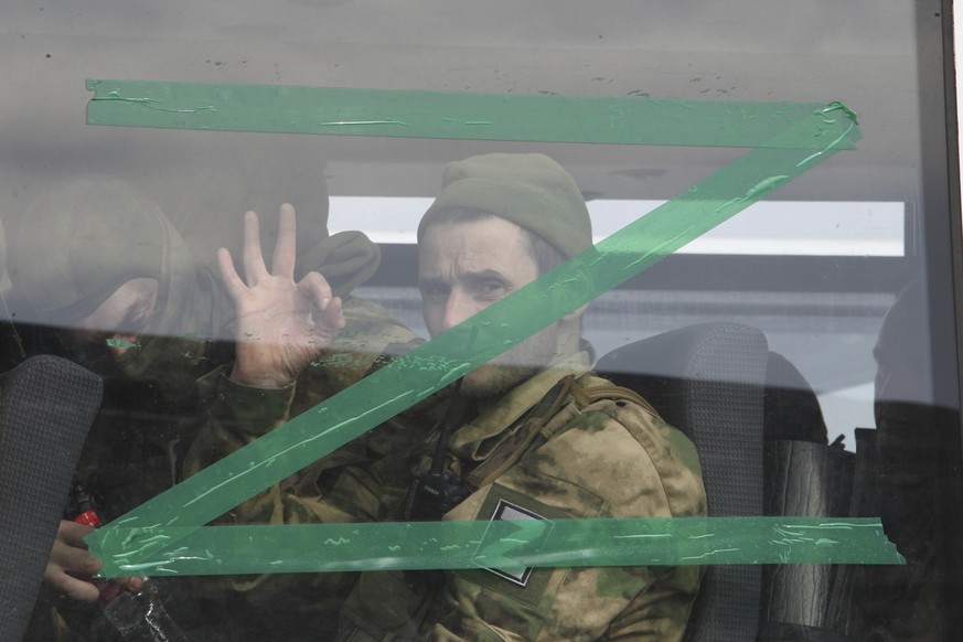 ARCHIV - 08.04.2022, Russland, Grosny: Ein Soldat macht ein Handzeichen aus dem Fenster eines Busses mit dem Buchstaben