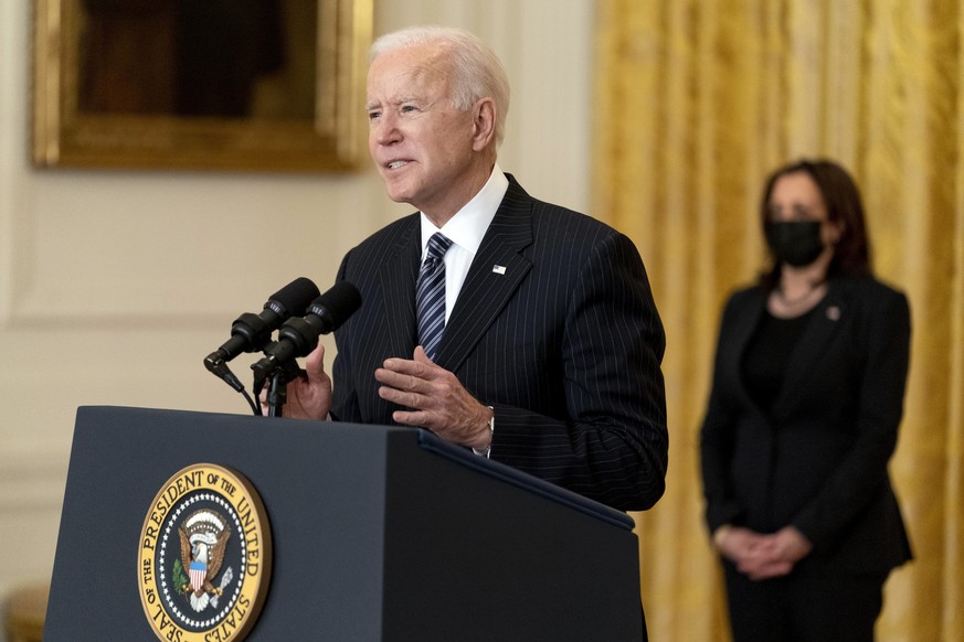 President Joe Biden, accompanied by Vice President Kamala Harris, right, speaks about COVID-19 vaccinations in the East Room of the White House, Thursday, March 18, 2021, in Washington. (AP Photo/Andr ...
