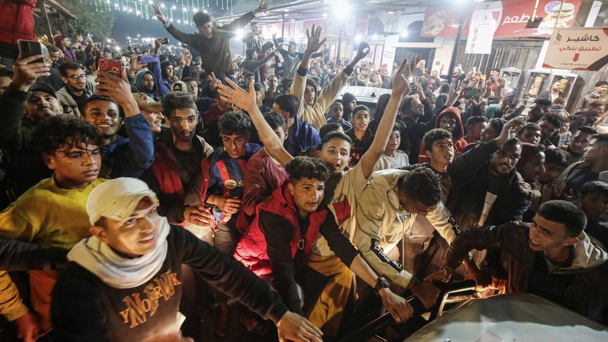 Palestinians react to news of a ceasefire agreement with Israel, in Deir al Balah, central Gaza Strip Palestinians react to news of a ceasefire agreement with Israel, in Deir al Balah, central Gaza St ...