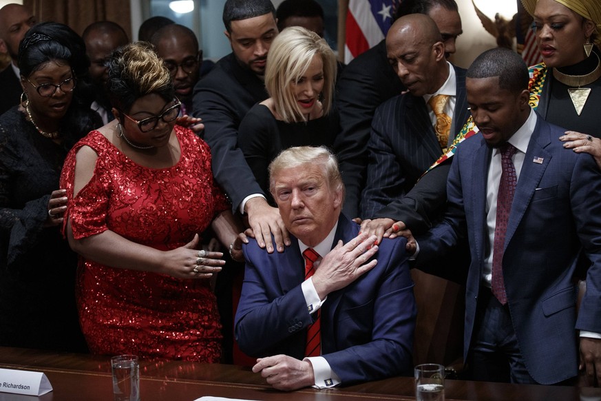 President Donald J. Trump, with African-American community, business, and faith leaders, prays in the Cabinet Room prior to the National African American History Month Reception at the White House in  ...