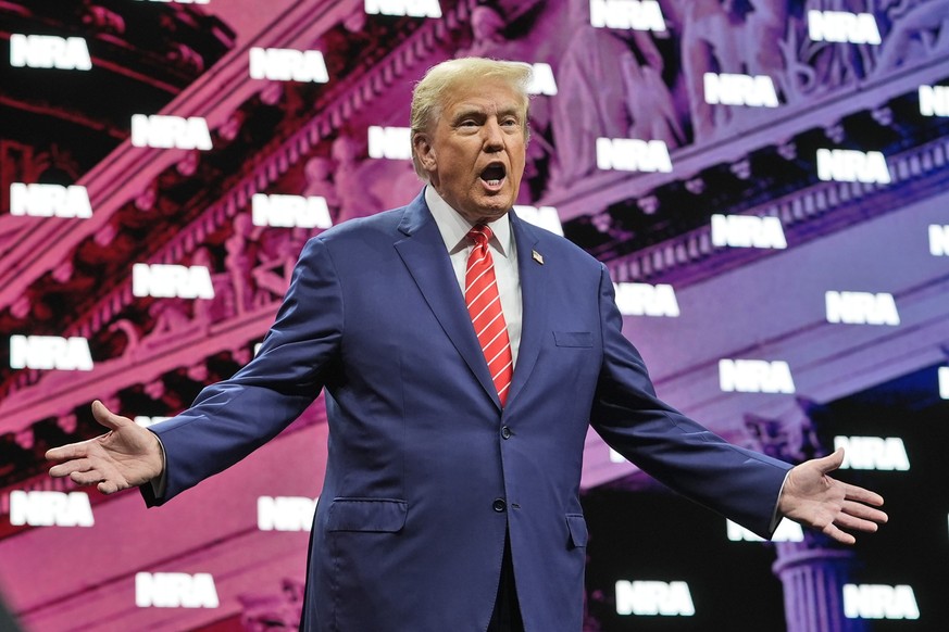 Former President Donald Trump gestures as he is applauded before speaking at the National Rifle Association Convention, Saturday, May 18, 2024, in Dallas. (AP Photo/LM Otero)