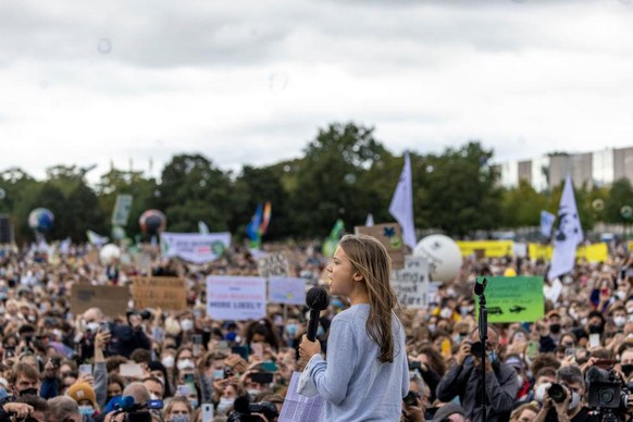 BERLIN, GERMANY - SEPTEMBER 24: Climate activist Greta Thunberg speaks at a large-scale climate strike march by Fridays for Future in front of the Reichstag on September 24, 2021 in Berlin, Germany. G ...
