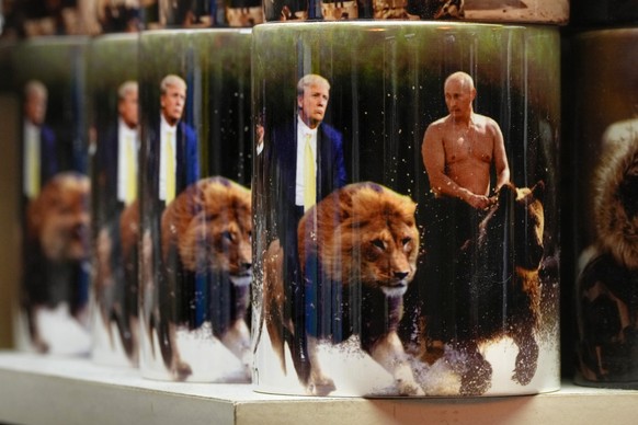 Cups with images of Russian President Vladimir Putin and U.S. President Donald Trump are displayed for sale at a souvenir shop in St. Petersburg, Russia, Thursday, Feb. 13, 2025. (AP Photo/Dmitri Love ...