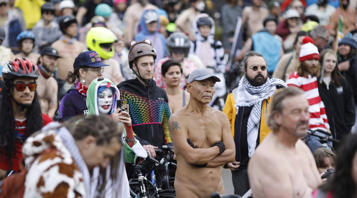 October 12, 2025, Portand, Oregon, USA: Participants gather in the Convention Center Plaza in Portland, Ore., before the start of the emergency Naked Bike Ride on Sunday, October 12, 2025. The protest ...
