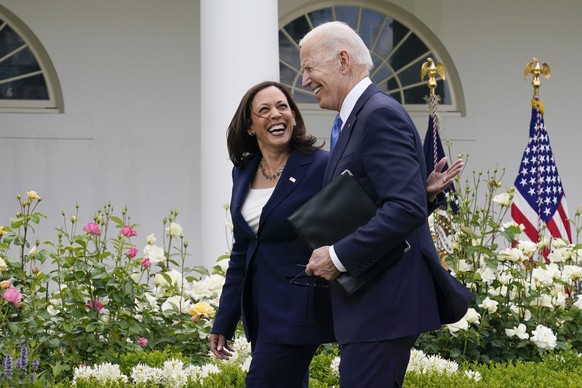 FILE - President Joe Biden, right, walks with Vice President Kamala Harris after speaking on updated guidance on face mask mandates and COVID-19 response, in the Rose Garden of the White House, May 13 ...