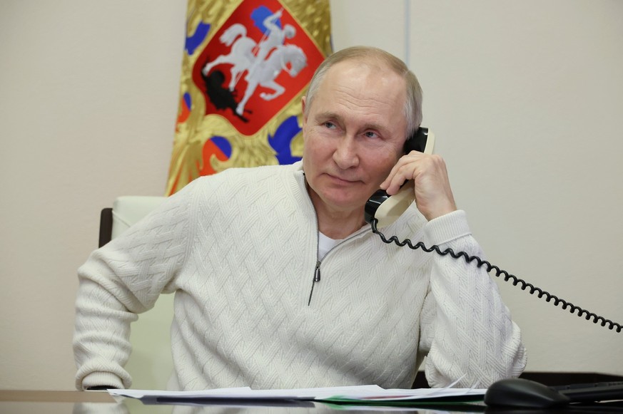 Russian President Vladimir Putin speaks on the phone to seven-year-old David Shmelev from Stavropol Krai region, a participant of the Fir Tree of Wishes charity campaign via videoconference from the N ...