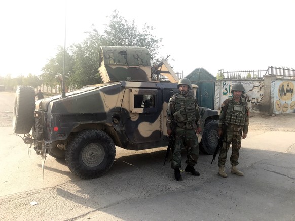 Afghan soldiers stand guard near the site of a blast in Kabul, Afghanistan July 15, 2018. Reuters/ Mohammad Ismail