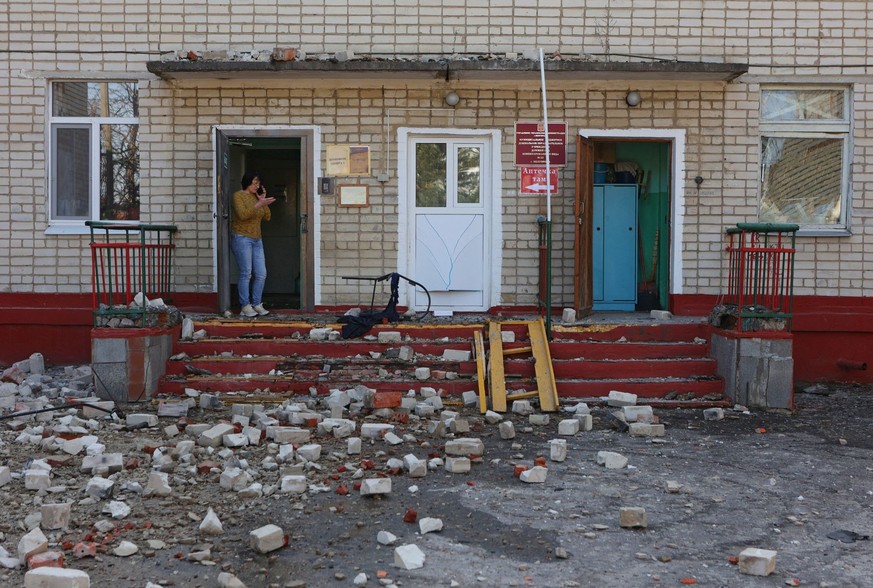 A woman stands at the entrance to a kindergarten building hit by shelling, what local authorities called a Ukrainian military strike, in the course of the Russia-Ukraine conflict in Belgorod, Russia M ...