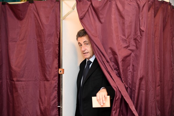 epaselect epa05639493 Former French president and candidate for the right-wing Les Republicains (LR) party primary ahead of the 2017 presidential election Nicolas Sarkozy leaves a polling booth as he ...