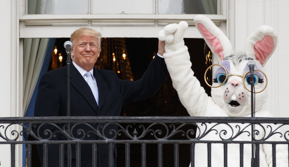 President Donald Trump and the Easter Bunny stand together on the Truman Balcony at the White House in Washington, Monday, April 2, 2018, during the annual White House Easter Egg Roll. (AP Photo/Carol ...