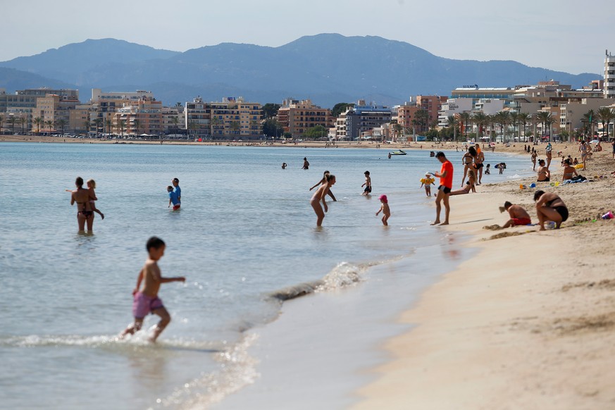 People sunbathe on El Arenal beach as some Spanish provinces are allowed to ease lockdown restrictions during phase two, amid the coronavirus disease (COVID-19) outbreak, in Mallorca, Spain, May 25, 2 ...