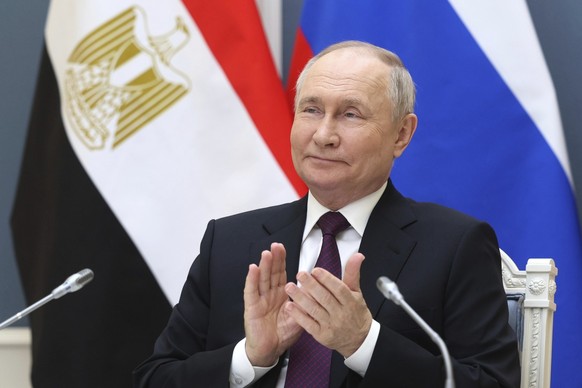 Russia&#039;s President Vladimir Putin applauds as he takes part in the official ceremony for pouring the first concrete into the foundation of power unit #4 at Egypt&#039;s El-Dabaa Nuclear Power Pla ...