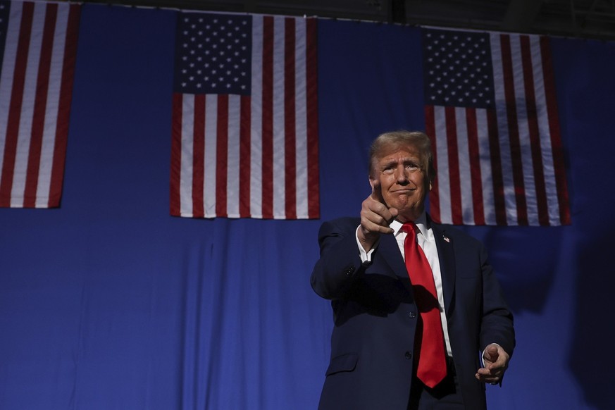 Former President Donald Trump greets the crowd at a campaign rally Saturday Dec. 16, 2023, in Durham, N.H. (AP Photo/Reba Saldanha)